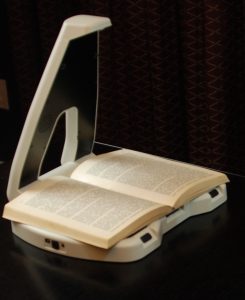 Image of the LyriQ Scan and Read Assistive Reader with a Book