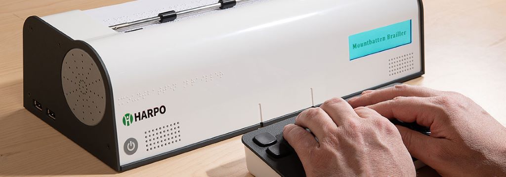 Image of a person typing on the Mountbatten Brailler Tutor