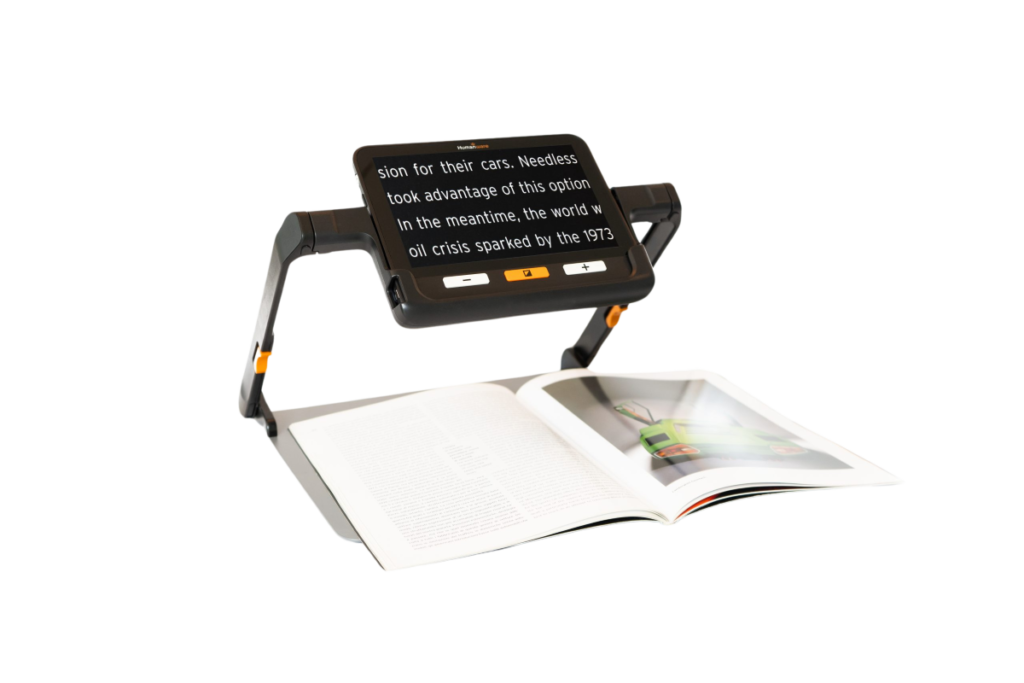 humanware explore 8 video magnifier on its stand viewing a magazine underneath