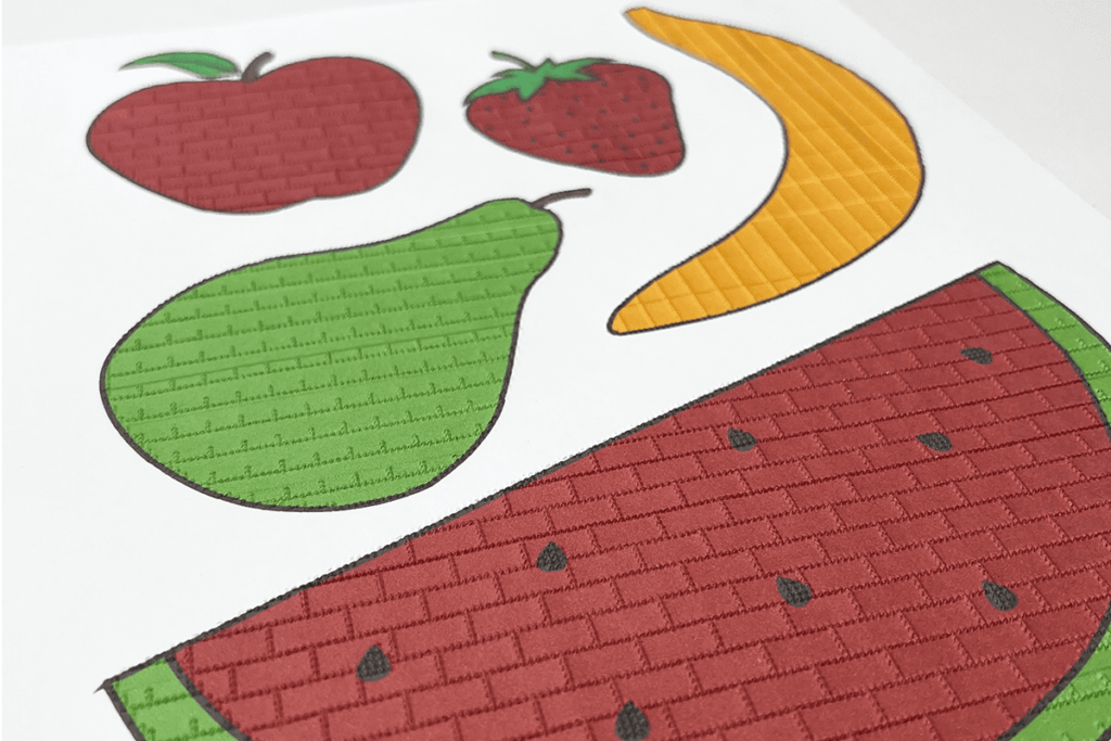 image of an embossed photo print of an apple, strawberry, banana, pear and watermelon by the embosser