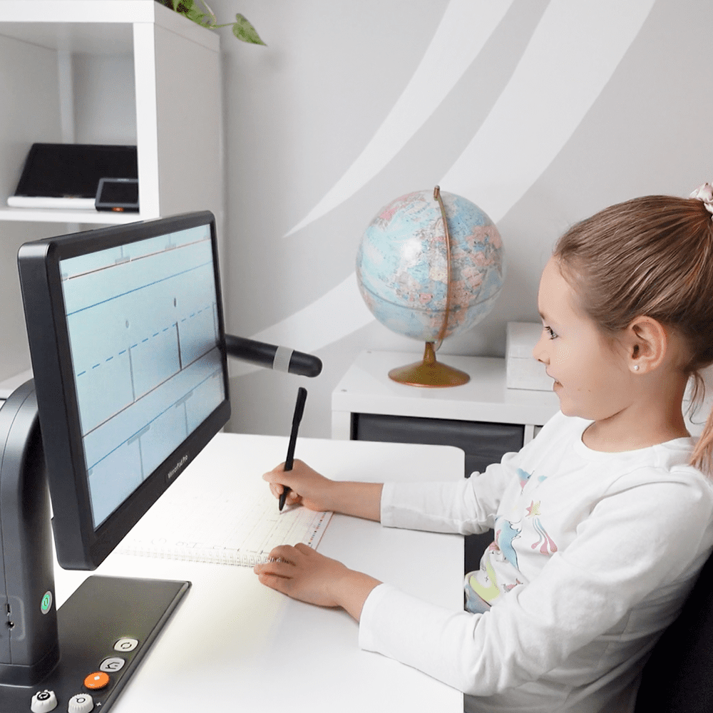 image of a student from the side sitting at a desk using the camera on the device to view her homework on the large screen